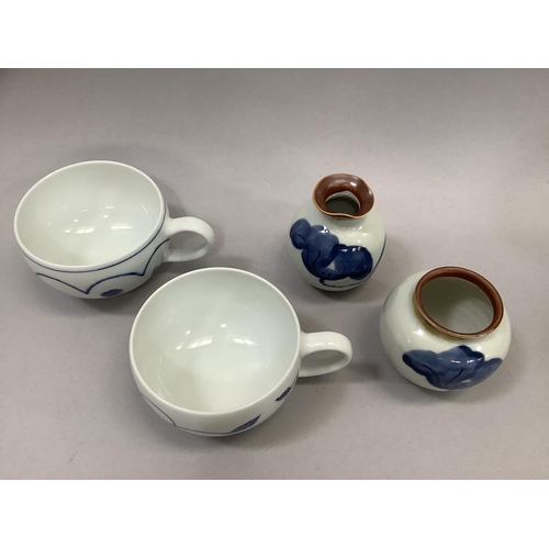 49 - A pair of Jingdezhen blue and white porcelain tea or coffee cups, each with floral decoration, marke... 