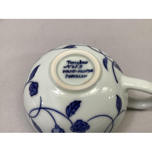 49 - A pair of Jingdezhen blue and white porcelain tea or coffee cups, each with floral decoration, marke... 