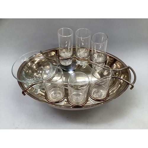 43 - A novelty silver plated oval form vodka shot glass, bottle and mixing bowl stand, with fitting area ... 