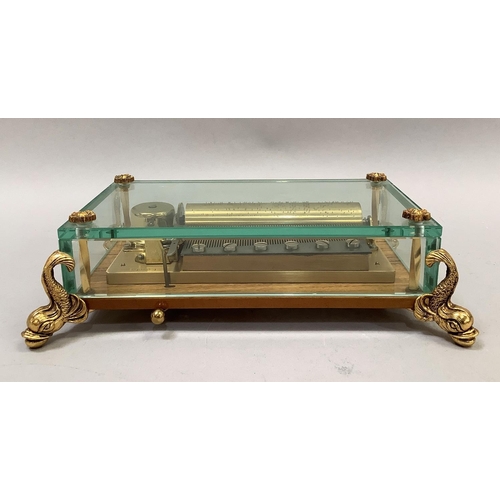 44 - A Contemporary Swiss made small single cylinder music box, made by Reuge Music, encased within a gla... 