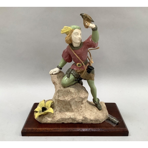 47 - A cast iron and enamelled figure of a huntsman on a rocky outcrop with a bird on his hand and one lo... 