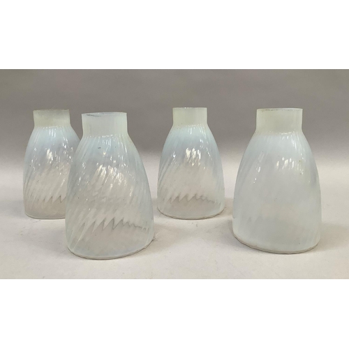 10 - A set of 4 vaseline glass shades of writhen moulding, 5cm diameter at neck, 10cm diameter at rim, 15... 