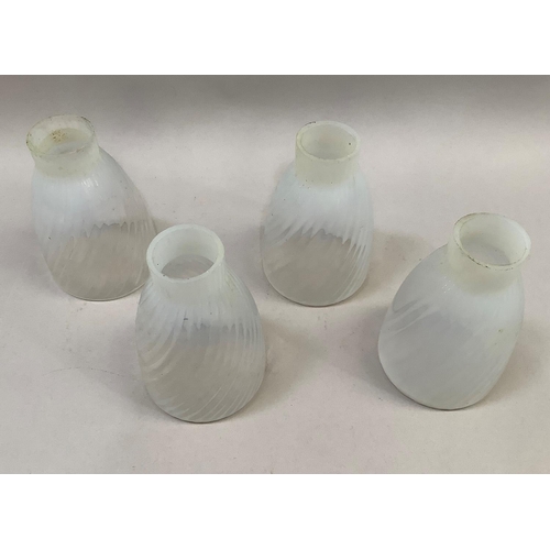 10 - A set of 4 vaseline glass shades of writhen moulding, 5cm diameter at neck, 10cm diameter at rim, 15... 