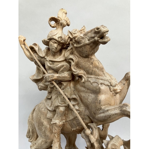 9 - A Grodner Holzschnitzerei wooden carving of St George slaying the dragon, on plinth base, unpainted ... 