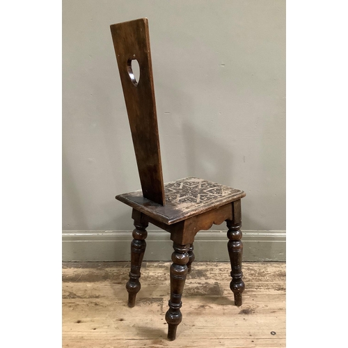 51 - A Victorian spinning chair with heart shaped cut out, carved with stylised flower, 40cm wide