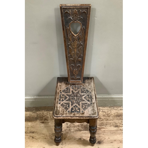 51 - A Victorian spinning chair with heart shaped cut out, carved with stylised flower, 40cm wide
