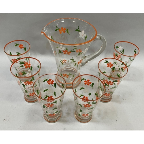 5 - A 1950s lemonade set, clear glass painted in orange, green and white flowers, comprising jug and six... 