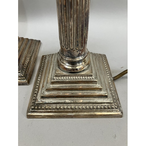23 - A pair of silver-plated Corinthian column table lamps on square stepped and beaded bases, 37.5cm hig... 