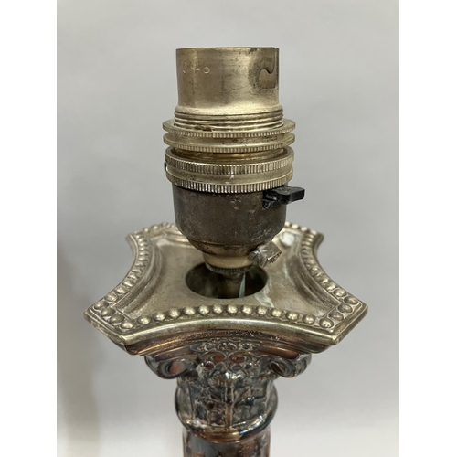 23 - A pair of silver-plated Corinthian column table lamps on square stepped and beaded bases, 37.5cm hig... 