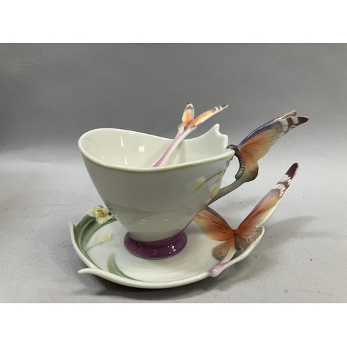 25 - A Franz porcelain butterfly design cup and saucer with spoon set and a butterfly cream jug with orig... 