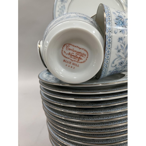 38 - A Noritake dinner and tea service of blue hill pattern comprising seventeen tea cups, nineteen sauce... 