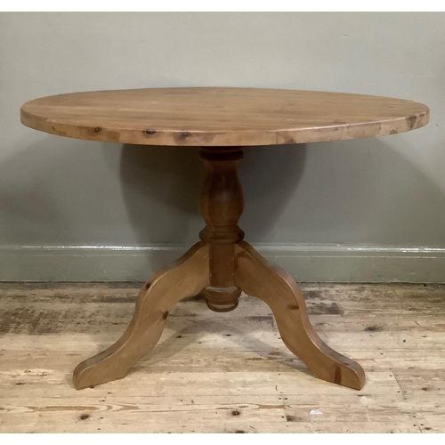 57 - A modern pine circular dining table on vase turned pedestal and four downswept legs, 105cm diameter,... 