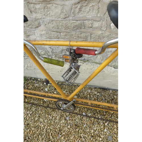 210 - A Four Seat Pacing Bicycle, yellow frame, with cranks, chain & duplex forks.

Please note we are una... 