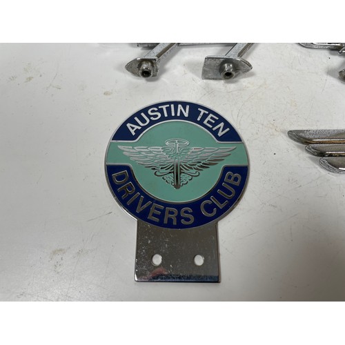 6 - Three vintage Austin cars Flying A bonnet mascots together with an Austin Ten Drivers Club badge

Th... 