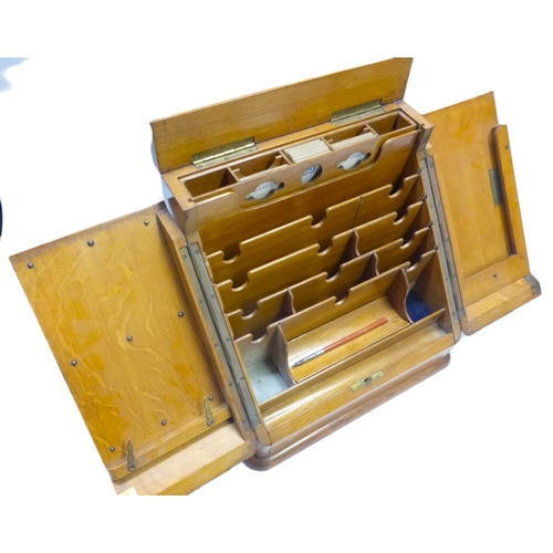 Writing Desk Compendium. A double opening cabinet in light oak, with ...