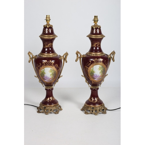 100 - A PAIR OF CONTINENTAL GILT BRASS AND POLYCHROME TABLE LAMPS each of urn form with decorated panels d... 