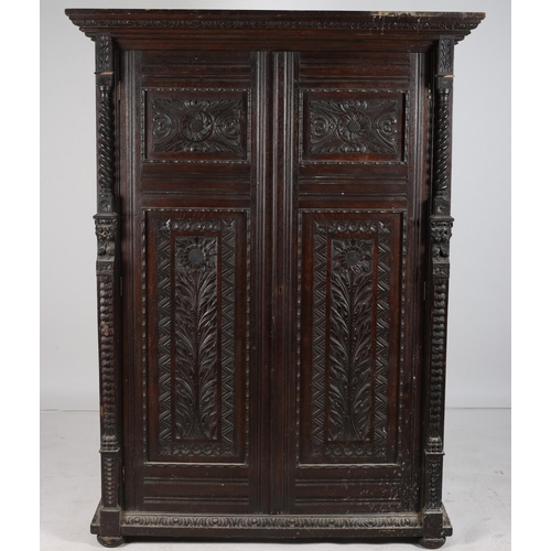 13 - A GOOD 19TH CENTURY CUPBOARD profusely carved overall with C-scrolls foliage and figural masks the s... 