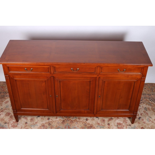 20 - A GRANGE CHERRYWOOD SIDEBOARD of rectangular outline with three frieze drawers and cupboards on squa... 