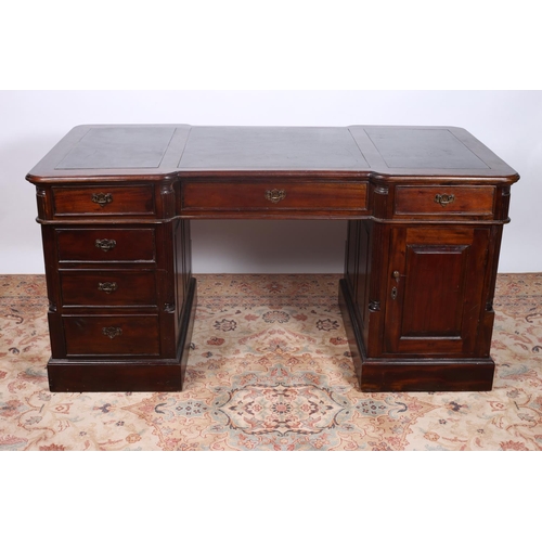 37 - A MAHOGANY PEDESTAL DESK the shaped top with black writing surface above three frieze drawers on twi... 
