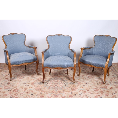 39 - A SET OF THREE CONTINENTAL BEECH FRAME AND UPHOLSTERED ARMCHAIRS each with a shaped top rail with ca... 