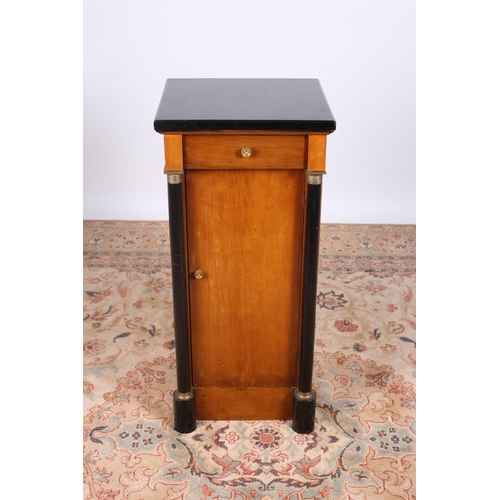 50 - A CONTINENTAL SATIN BIRCH AND EBONISED PEDESTAL the square moulded top with frieze drawer and cupboa... 