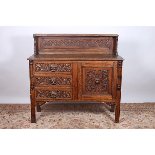 62 - A VINTAGE CARVED OAK SIDEBOARD the raised superstructure and carved panel the base with three frieze... 