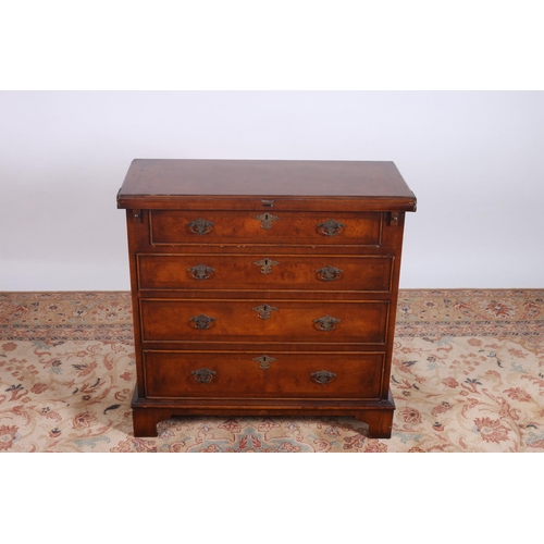 72 - A GEORGIAN DESIGN WALNUT CROSS BANDED BACHELOR'S CHEST the rectangular hinged top above four long gr... 