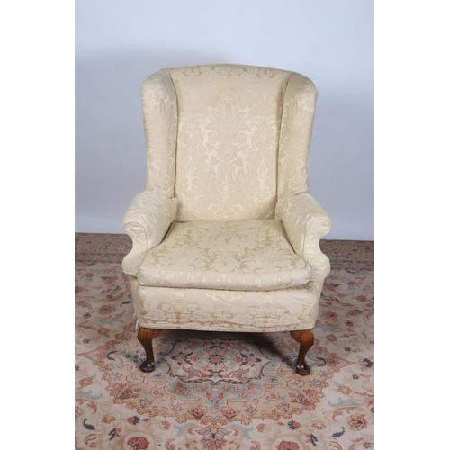 77 - A MAHOGANY AND UPHOLSTERED WING CHAIR with loose cushion and scroll over arms on cabriole legs with ... 