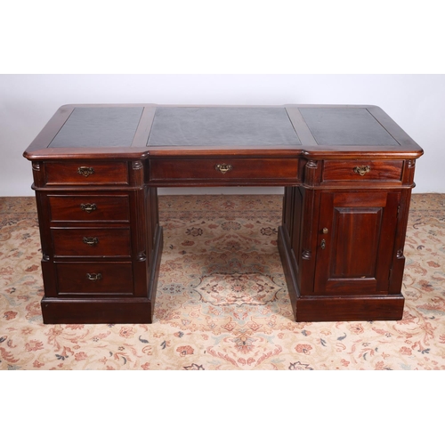 83 - A MAHOGANY PEDESTAL DESK the shaped top with black inset writing surface and three frieze drawers ra... 