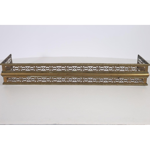 85 - A 19TH CENTURY PIERCED BRASS FENDER with gadrooned top rail on platform base 19cm (h) x 115cm (w) x ... 