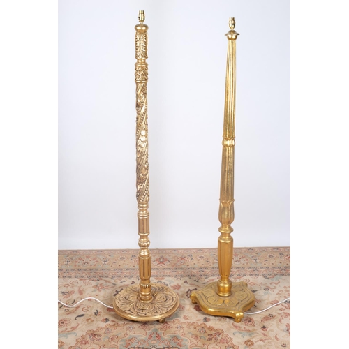 92 - A CONTINENTAL CARVED GILT WOOD FLOOR STANDING LAMP together with a similar example (2)