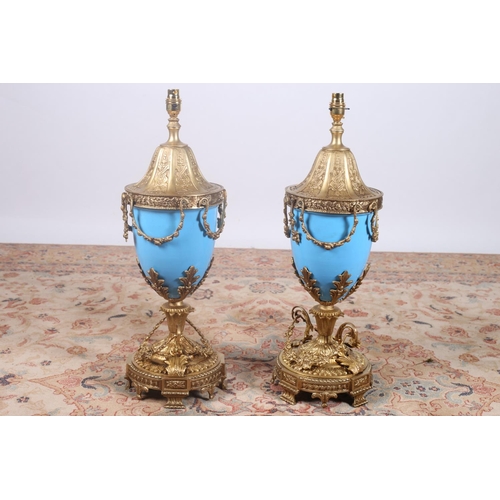 93 - A PAIR OF CONTINENTAL GILT BRASS BLUE PAINTED TABLE LAMPS each of urn form hung with floral festoons... 