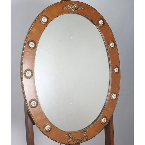 99 - A CONTINENTAL STAINED WOOD AND GILT BRASS MOUNTED MIRROR the oval plate within a moulded frame with ... 