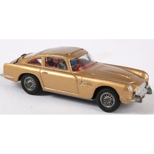 235 - James Bond. Corgi Toys, 007’s Aston Martin DB5. from the film “Goldfinger”, gold body with red inter... 