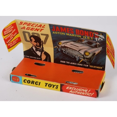 235 - James Bond. Corgi Toys, 007’s Aston Martin DB5. from the film “Goldfinger”, gold body with red inter... 