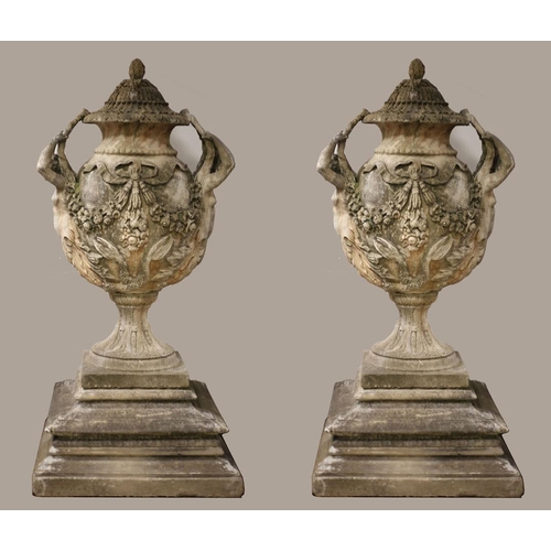 101 - A VERY FINE AND IMPRESSIVE PAIR OF SANDSTONE URNS each of ovoid tapering form hung with ribbon tied ... 