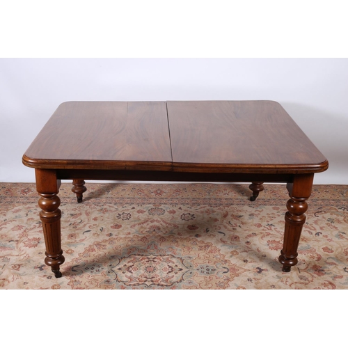 10 - A 19TH CENTURY MAHOGANY TELESCOPIC DINING TABLE the rectangular top with rounded corners and two loo... 