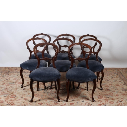 11 - A SET OF EIGHT VICTORIAN DESIGN CARVED MAHOGANY DINING CHAIRS each with a foliate carved top rail an... 