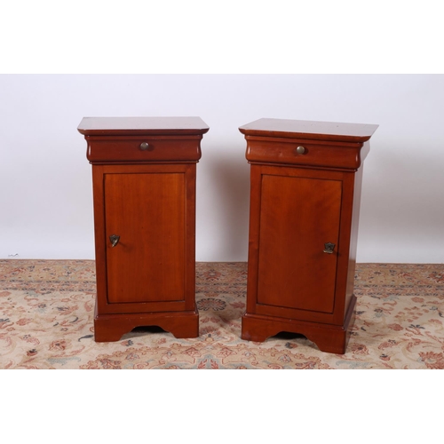 12 - A PAIR OF CHERRYWOOD PEDESTALS the rectangular tops with frieze drawers and cupboards on shaped plat... 