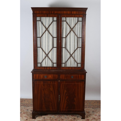22 - A MAHOGANY LIBRARY BOOKCASE the dentil moulded cornice above a pair of astragal glazed doors the int... 