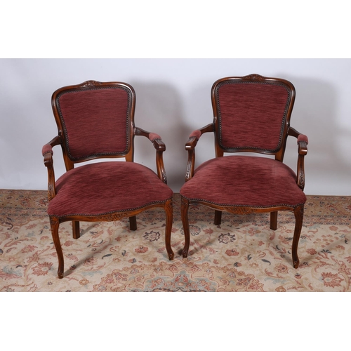 31 - A PAIR OF CONTINENTAL AND BEECHWOOD UPHOLSTERED ARMCHAIRS each with a foliate carved top rail above ... 