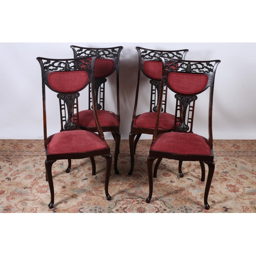 4 - A SET OF FOUR EDWARDIAN CARVED MAHOGANY AND UPHOLSTERED DRAWING ROOM CHAIRS each with a curved top r... 