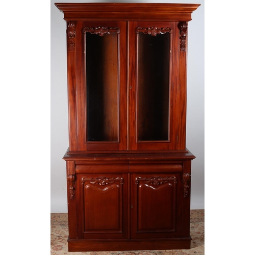 47 - A VICTORIAN DESIGN MAHOGANY TWO DOOR LIBRARY BOOKCASE the moulded cornice above a pair of bevelled g... 