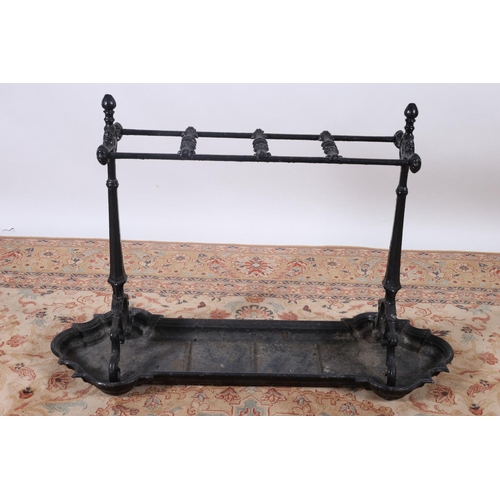 5 - A CAST IRON FOUR COMPARTMENT STICK STAND of rectangular outline with scroll and moulded uprights wit... 