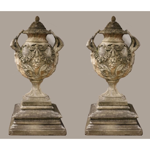 50 - A VERY FINE AND IMPRESSIVE PAIR OF SANDSTONE URNS each of ovoid tapering form hung with ribbon tied ... 