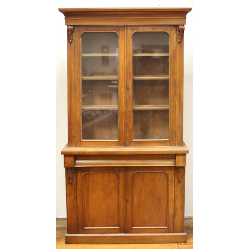 55 - A VICTORIAN MAHOGANY LIBRARY BOOKCASE the moulded cornice above a pair of glazed doors containing ad... 