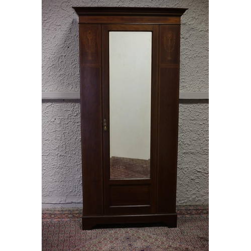 56 - AN EDWARDIAN MAHOGANY AND SATINWOOD INLAID WARDROBE the moulded cornice above a bevelled glass mirro... 