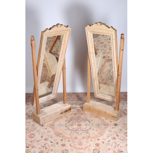 574 - A PAIR OF VINTAGE PINE CHEVAL MIRRORS each with a rectangular plate within a moulded frame on moulde... 