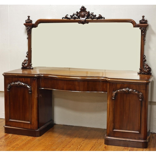 58 - A VICTORIAN MAHOGANY MIRRORED BACK SIDEBOARD of serpentine outline with cartouche and carved C-scrol... 