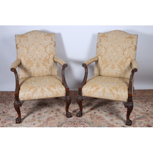 65 - A PAIR OF GAINSBOROUGH STYLE CARVED MAHOGANY ELBOW CHAIRS each with a rectangular shape back and sea... 